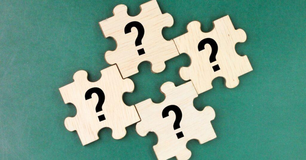 wooden puzzle pieces with question marks, indicating LASIK FAQs.