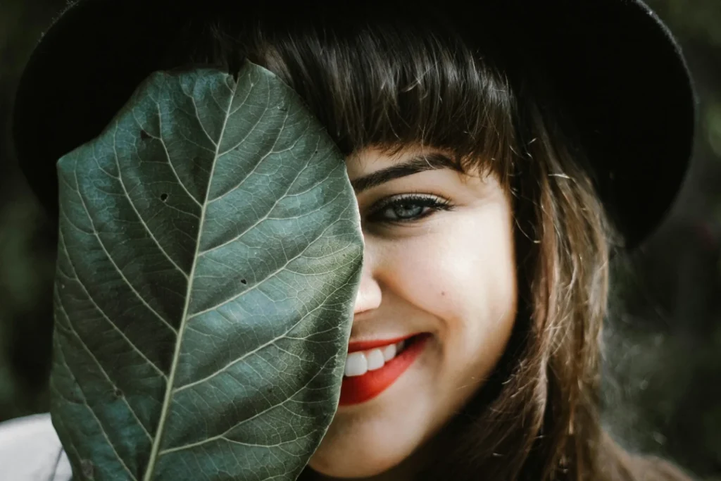 woman holding leaf - eyes focused