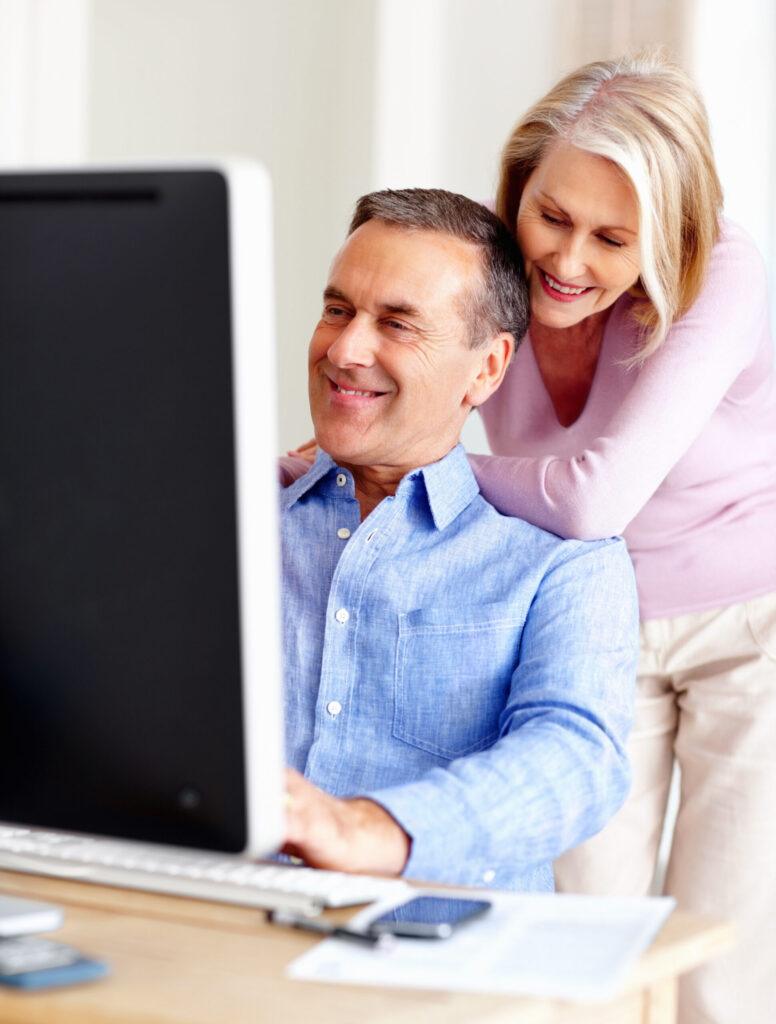 happy-mature-couple-with-a-man-working-on-computer-2025-04-06-12-42-40-utc
