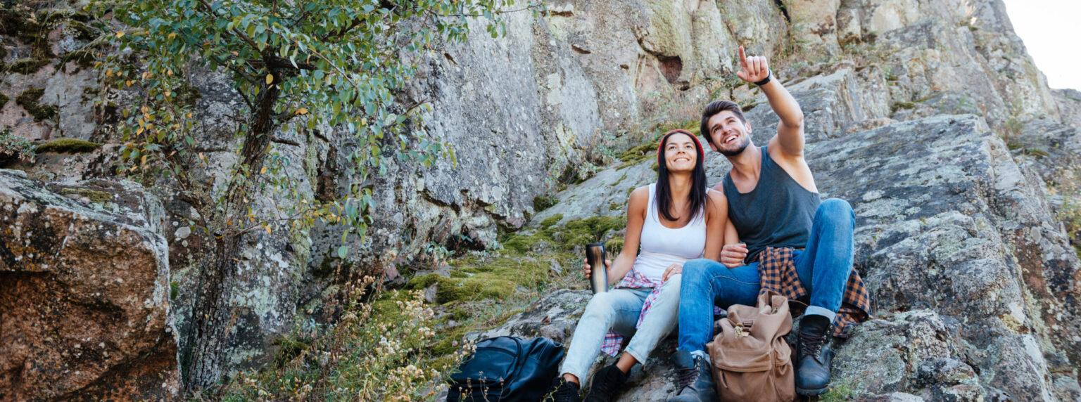 young1-active-couple-enjoying-view-from-top-of-a-mo-2025-02-14-12-52-06-utc-scaled