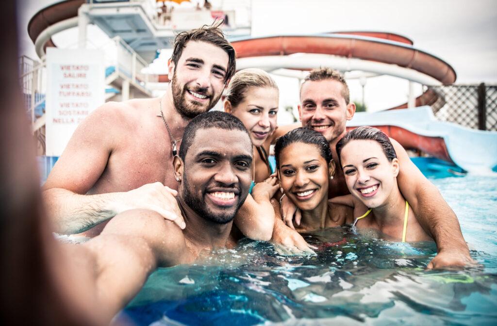 Group of friends making party in the pool
